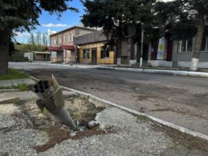 A part of a rocket sits wedged in the ground on a street in the recaptured town of Lyman, Ukraine, Friday, Oct. 7, 2022. Ukrainian authorities are just beginning to sift through the wreckage of the devastated city of Lyman in eastern Ukraine as they assess the humanitarian toll, and possibility of war crimes, from a months-long Russian occupation. (AP Photo/Justin Spike)