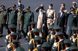 In this picture released by the official website of the office of the Iranian supreme leader, Supreme Leader Ayatollah Ali Khamenei, center, reviews a group of armed forces cadets during their graduation ceremony accompanied by commanders of the armed forces, at the police academy in Tehran, Iran, Monday, Oct. 3, 2022. Khamenei responded publicly on Monday to the biggest protests in Iran in years, breaking weeks of silence to condemn what he called “rioting” and accuse the U.S. and Israel of planning the protests. (Office of the Iranian Supreme Leader via AP)
