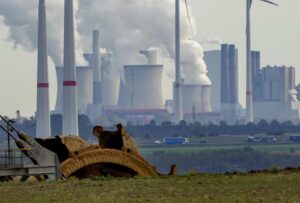 FILE – Steam comes out of the chimneys of the coal-fired power station Neurath near the RWE Garzweiler open-cast coal mine in Luetzerath, Germany, Monday, Oct.25, 2021. German energy giant RWE says it will phase out the burning of coal by 2030, saving 280 million metric tons of climate-changing greenhouse gas emissions. The decision announced Tuesday will accelerate the closure of some of Europe’s most polluting power plants and a vast lignite strip mine in the west of the country. (AP Photo/Michael Probst, File)