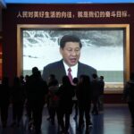 Chinese President Xi Jinping is seen on a big screen below the slogan “The People’s desire for the good life, is the goal of our efforts” at the Museum of the Community Party of China in Beijing, Wednesday, Oct. 12, 2022. A meeting of the ruling Communist Party to install leaders gives President Xi Jinping, China’s most influential figure in decades, a chance to stack the ranks with allies who share his vision of intensifying pervasive control over entrepreneurs and technology development. (AP Photo/Ng Han Guan)