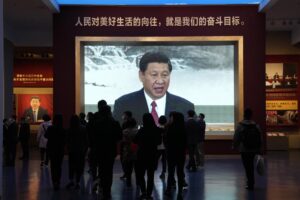 Chinese President Xi Jinping is seen on a big screen below the slogan “The People’s desire for the good life, is the goal of our efforts” at the Museum of the Community Party of China in Beijing, Wednesday, Oct. 12, 2022. A meeting of the ruling Communist Party to install leaders gives President Xi Jinping, China’s most influential figure in decades, a chance to stack the ranks with allies who share his vision of intensifying pervasive control over entrepreneurs and technology development. (AP Photo/Ng Han Guan)