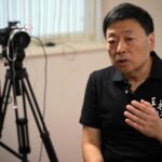 Wang Zhi’an speaks during an interview with the Associated Press in Tokyo on Oct. 5, 2022. Chinese investigative journalist Wang once exposed corruption, land seizures, and medical malpractice for state broadcaster CCTV. Today, he’s in exile in Japan, and starting again as an independent journalist on YouTube. (AP Photo/Eugene Hoshiko)