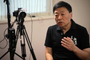Wang Zhi’an speaks during an interview with the Associated Press in Tokyo on Oct. 5, 2022. Chinese investigative journalist Wang once exposed corruption, land seizures, and medical malpractice for state broadcaster CCTV. Today, he’s in exile in Japan, and starting again as an independent journalist on YouTube. (AP Photo/Eugene Hoshiko)