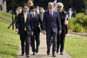 Japan’s Prime Minister Fumio Kishida, front left, walks with Australian Prime Minister Anthony Albanese, front right, during a visit to Kings Park in Perth, Australia, Saturday, Oct. 22, 2022. Kishida visit is to bolster military and energy cooperation between Australia and Japan amid their shared concerns about China. (Stefan Gosatti/Pool Photo via AP)