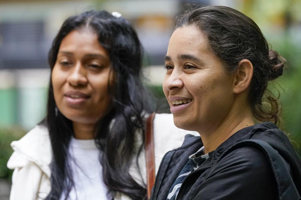 Venezuelans Yeysy Hernandez, left, and Candy Cegarra speak during an interview with The Associated Press, Thursday, Oct. 13, 2022, in New York. (AP Photo/Mary Altaffer)