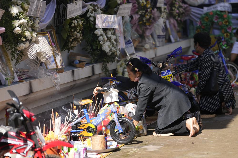Relatives of the victims of a mass killing attack gather for a Buddhist ceremony inside Wat Rat Samakee temple in Uthai Sawan, north eastern Thailand, Tuesday, Oct. 11, 2022. A former police officer burst into a day care center in northeastern Thailand on Thursday, killing dozens of preschoolers and teachers before shooting more people as he fled. (AP Photo/Sakchai Lalit)