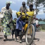 Residents flee fighting between M23 rebels and Congolese forces near Kibumba, some 20 kms ( 12 miles) North of Goma, Democratic Republic of Congo, Friday Oct. 28, 2022. Hundreds have been killed and nearly 200,000 people displaced since fighting erupted a year ago. Congo has long accused Rwanda of backing the rebels. (AP Photo/Justin Kabumba)