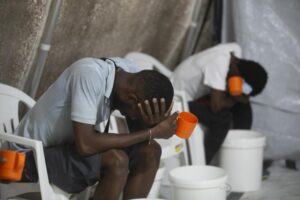 Patients with cholera symptoms sit in an observation center at a cholera clinic run by Doctors Without Borders in Port-au-Prince, Haiti, Friday, Oct. 7, 2022. (AP Photo/Odelyn Joseph)