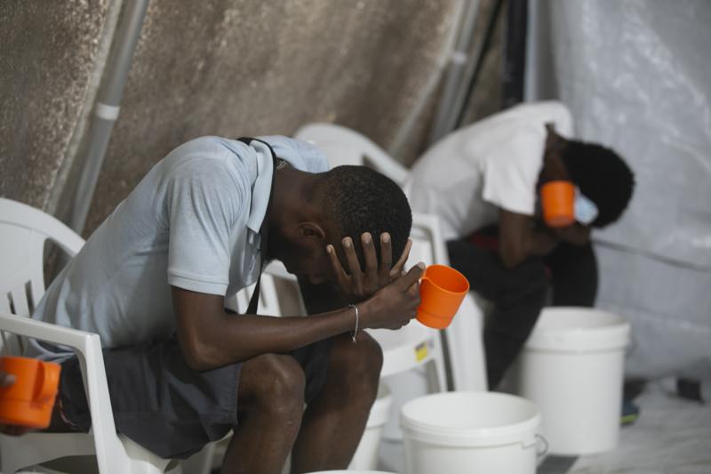 Patients with cholera symptoms sit in an observation center at a cholera clinic run by Doctors Without Borders in Port-au-Prince, Haiti, Friday, Oct. 7, 2022. (AP Photo/Odelyn Joseph)