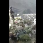 In this frame grab from video that was likely taken by the Taliban and posted online and provided by Afghan Witness, a UK-based open-source nonprofit, a Taliban fighter stands amid bodies on the ground, in the Dara district, of Panjshir province, Afghanistan, Sept. 14, 2022. The Taliban captured, bound and shot to death 27 men in Afghanistan’s Panjshir Valley last month during an offensive against resistance fighters in the area, according to a new report by Afghan Witness published Tuesday, Oct. 18, 2022 refuting the group’s earlier claims that the men were killed in battle. (Afghan Witness via AP)