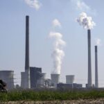 FILE – A mother pushes a stroller in front of the Scholven coal-fired power station, owned by Uniper, in Gelsenkirchen, Germany, March 28, 2022. The world remains “far behind” and is not doing nearly enough to reach any of the global goals limiting future warming, a United Nations report said. (AP Photo/Martin Meissner, File)