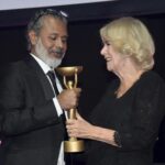 Britain’s Camilla, Queen Consort, presents winner Shehan Karunatilaka with the trophee for “The Seven Moons of Maali Almeida” during the Booker Prize at the Roundhouse in London, Monday Oct. 17, 2022. (Toby Melville/Pool Photo via AP)