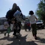 FILE – A migrant family from Venezuela walks to a Border Patrol transport vehicle after they and other migrants crossed the U.S.-Mexico border and turned themselves in June 16, 2021, in Del Rio, Texas. The Biden administration has agreed to accept up to 24,000 Venezuelan migrants, similar to how Ukrainians have been admitted after Russia’s invasion, while Mexico has agreed to accept some Venezuelans who are expelled from the United States, the two nations said Wednesday, Oct. 12, 2022. (AP Photo/Eric Gay, File)