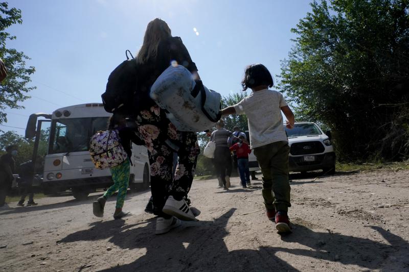 FILE – A migrant family from Venezuela walks to a Border Patrol transport vehicle after they and other migrants crossed the U.S.-Mexico border and turned themselves in, Wednesday, June 16, 2021, in Del Rio, Texas. The Biden administration is developing plans for Venezuelans with financial sponsors to be granted parole to enter the United States, similar to how Ukrainians have been admitted after Russia’s invasion, U.S. officials said Tuesday, Oct. 11, 2022. (AP Photo/Eric Gay, File)