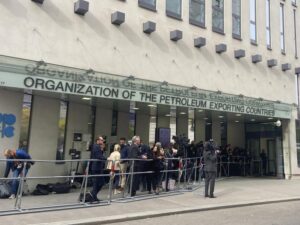 FILE – People and media gather at the entrance of the building of the Organization of the Petroleum Exporting Countries, OPEC, in Vienna, Austria on Oct. 5, 2022. Saudi Arabia said Thursday, Oct. 13, 2022 that the U.S. had urged the kingdom to postpone a decision by OPEC and its allies, including Russia, to cut oil production by a month which would have been just before the upcoming American midterm elections. (AP Photo/Philipp-Moritz Jenne, File)