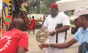Chief Emeka Agba welcoming a masquerade during the New Yam Festival