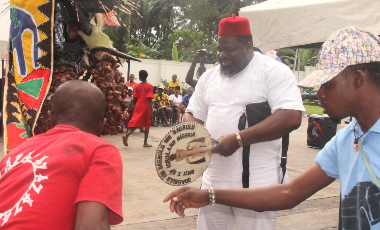 Chief Emeka Agba welcoming a masquerade during the New Yam Festival