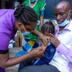 Oluwafikayomi receiving her measles vaccination