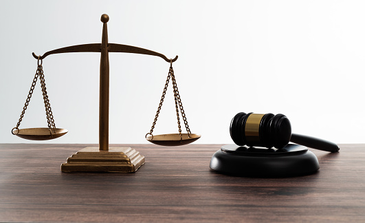 Gavel and scales of justice on the table.