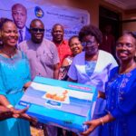 Mrs Divine Iniovosa, Vice Chairman of Warri South, (2nd left) presenting the equipment to Dr Oritsematosan Sagay, the Executive Secretary, Primary Health care Authority, Warri South, while others look on