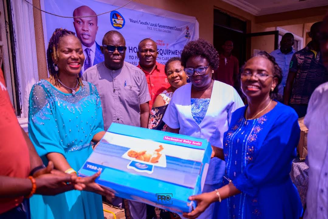 Mrs Divine Iniovosa, Vice Chairman of Warri South, (2nd left) presenting the equipment to Dr Oritsematosan Sagay, the Executive Secretary, Primary Health care Authority, Warri South, while others look on