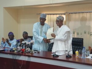NUC Executive Secretary Prof Abubakar Rasheed handing over the provisional license of the new university to Osun State Governor, Adegboyega Oyetola, at the NUC headquarters in Abuja, on Thursday