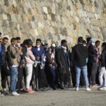 Migrants disembark from the German humanitarian ship Rise Above docked in the southern Italian port town of Reggio Calabria, Tuesday, Nov. 8, 2022.German humanitarian group Mission Lifeline said its ship docked in southern Italy early Tuesday and disembarked the 89 people it had rescued in the central Mediterranean. (AP Photo/Valeria Ferraro)
