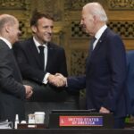 U.S. President Joe Biden, French President Emmanuel Macron and German Chancellor Olaf Scholz greet each other during the first working session of the G20 leaders’ summit in Nusa Dua, Indonesia, Tuesday, Nov. 15, 2022. (Kevin Lamarque/Pool via AP)