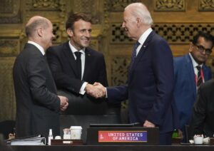 U.S. President Joe Biden, French President Emmanuel Macron and German Chancellor Olaf Scholz greet each other during the first working session of the G20 leaders’ summit in Nusa Dua, Indonesia, Tuesday, Nov. 15, 2022. (Kevin Lamarque/Pool via AP)