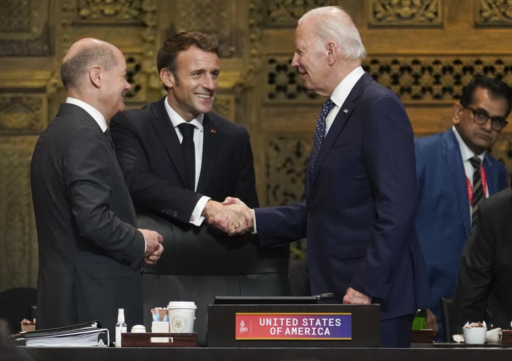 U.S. President Joe Biden, French President Emmanuel Macron and German Chancellor Olaf Scholz greet each other during the first working session of the G20 leaders’ summit in Nusa Dua, Indonesia, Tuesday, Nov. 15, 2022. (Kevin Lamarque/Pool via AP)