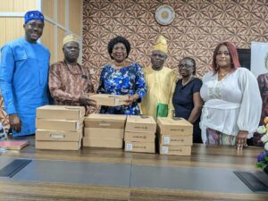 Prof Salius (2nd left) presenting laptop to LASU VC, Prof Olatunji-Bello, Dr Akomilafe and others watch with interest
