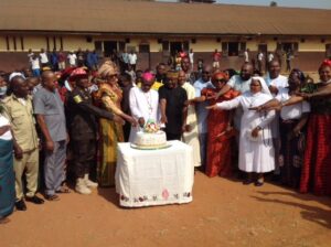 Archbishop Okeke with other priests and officials of Onitsha Correctional Centre cutting Christmas Cake for the inmates