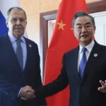 FILE – In this photo released by the Russian Foreign Ministry Press Service, Russian Foreign Minister Sergey Lavrov, left, and Chinese Foreign Minister Wang Yi pose for a photo prior to their talks on the sideline of the 12th East Asia Summit foreign ministers’ meeting in Phnom Penh, Cambodia, on Aug. 5, 2022. Wang defended his country’s position on the war in Ukraine on Sunday, Dec. 25, and signaled that China would deepen ties with Russia in the coming year while striving to bring US China ties back on the right course. (Russian Foreign Ministry Press Service via AP, File)