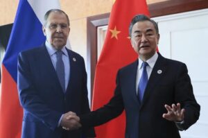 FILE – In this photo released by the Russian Foreign Ministry Press Service, Russian Foreign Minister Sergey Lavrov, left, and Chinese Foreign Minister Wang Yi pose for a photo prior to their talks on the sideline of the 12th East Asia Summit foreign ministers’ meeting in Phnom Penh, Cambodia, on Aug. 5, 2022. Wang defended his country’s position on the war in Ukraine on Sunday, Dec. 25, and signaled that China would deepen ties with Russia in the coming year while striving to bring US China ties back on the right course. (Russian Foreign Ministry Press Service via AP, File)