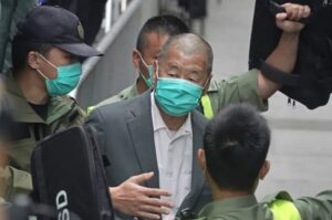 FILE – Democracy advocate Jimmy Lai, center, leaves the Hong Kong’s Court of Final Appeal in Hong Kong on Feb. 9, 2021. Lai was sentenced to five years and nine months in prison over two fraud charges linked to lease violations in Hong Kong on Saturday, Dec. 10, 2022 the latest of a series of cases against prominent activists that critics say are aimed at snuffing out dissidents in the city. (AP Photo/Kin Cheung, File)