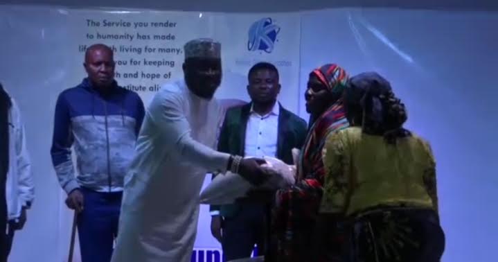 Kefas Ropshik presenting food items to widows