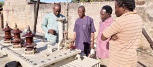 Mr Ade (2nd left) attending to members of a Kaduna community who brought a faulty transformer to him for repair