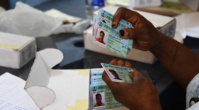 Officials-of-the-Independent-National-Electoral-Commission-INEC-sit-to-distribute-Permanent-Voter-Cards-to-prospective-voters-at-a-ward-in-Lagos-2