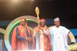 Prof Folasade Ogunsola (middle) holding UNILAG Mace flanked by Dr Chris Maiyaki (right) and Dr Olanrewaju Tejuoso (left) at investiture ceremony of Ogunsola as 13th VC