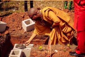 Charles Oguibe below performing the foundation laying ceremony