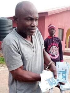 The suspect with some of the fake naira notes