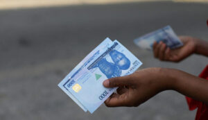A person holds a new 1000 Naira note as the Central Bank of Nigeria releases the notes to the public through the banks in Abuja