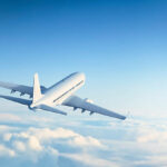 Commercial jet flying above clouds.