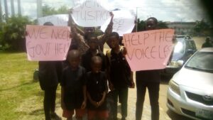 Children, wife and sister of the deceased during the protest in Benin City