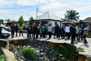 Cross River Governor Bassey Otu and his Deputy, Peter Odey, at a failed portion of one of the erosion sites at Yellow Duke Road