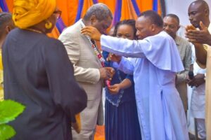 Rev . Prof Umeogu decorating the Vice Chancellor