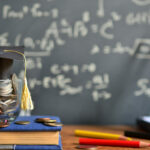 hat graduation model on money coins saving for concept investment education and scholarship