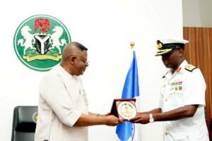 Flag Officer, Eastern Naval Command, Rear Admiral OK Oluwagbire, presenting a plaque to Gov Otu (left) during a courtesy call on the Governor in Government House Calabar