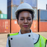 Cheerful factory worker woman in hard hat smiling and looking at camera, Happiness Female engineers for concept