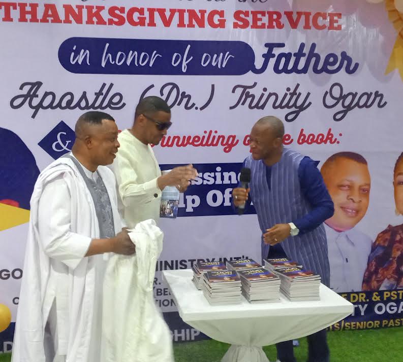 Deputy Governor Odey (middle), Apostle Ogar (left) and Bishop Isong (right) unveiling the book at Gold City Church Calabar, Cross River
